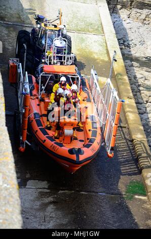 Launching Porthcawl lifeboat called out to an emergency on Porthcawl beach by ttractor Wales Cymru K GB Stock Photo