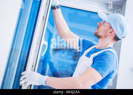 Brand New Plastic Windows Installation by Professional Caucasian Installer in His 30s. Stock Photo