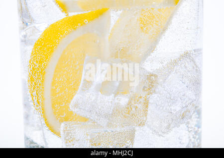 Ice, lemon slices and crystal clear water in a glass. Stock Photo