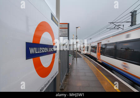 A London Overground class 378 capital star train departing Willesden Junctionn High level with the station sign and overground logo Stock Photo