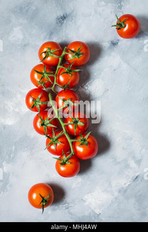 Fresh cherry tomatoes on stone background. Organic food Stock Photo