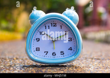 Alarm Clock on ground Stock Photo