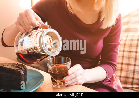 Close up view of woman pouring coffee into the cup. Business lunch Stock Photo