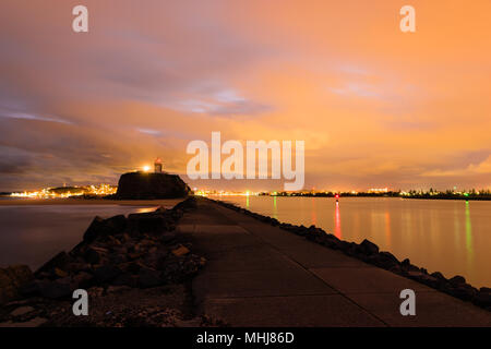 Newcastle, New South Wales, Australia. Light pollution reflecting off the clouds onto the water of the Hunter River at Nobbys Head in Newcastle. Stock Photo