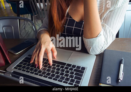 Business women sit on working table which have notebook and memo book and women's bag Stock Photo