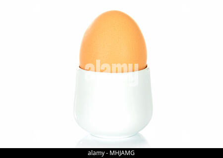 Boiled egg in an egg cup on a white background. Stock Photo