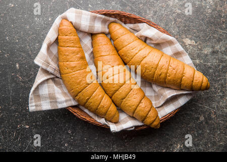 Salty bread rolls. Wholemeal croissants in basket. Stock Photo