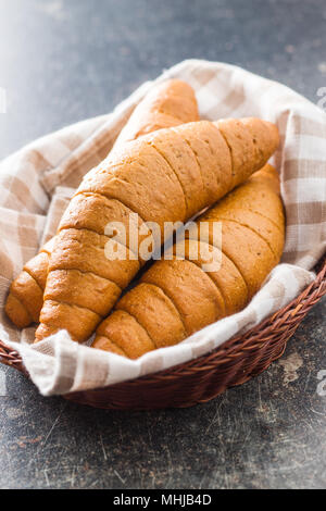 Salty bread rolls. Wholemeal croissants in basket. Stock Photo