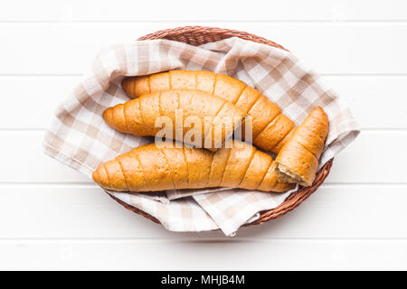 Salty bread rolls. Wholemeal croissants in basket. Stock Photo