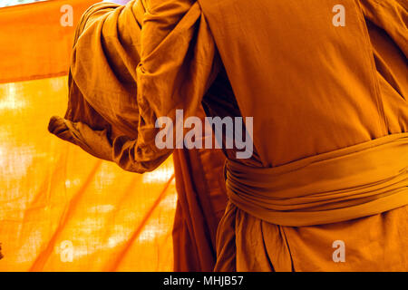 Yellow robe of Buddhist monks, Closeup on buddhist monk Stock Photo