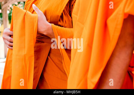 Yellow robe of Buddhist monks, Closeup on buddhist monk Stock Photo