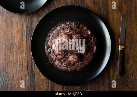 Chocolate Profiterole Cake on Black Plate. Dessert Concept. Stock Photo