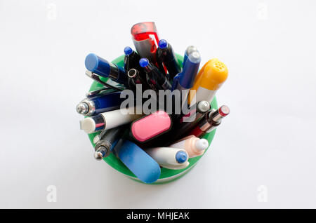 plenty of colored pens in holder isolated on white background, top view Stock Photo