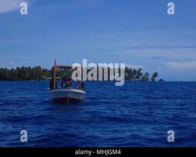 A dive boat anchored at a dive site near Weno in Truk Lagoon Stock Photo