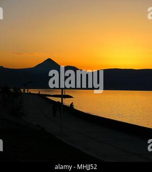 Sun  setting behind the mountains. Stock Photo