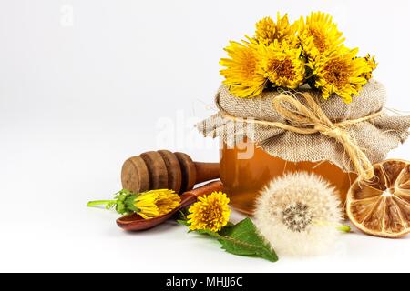 Fresh dandelion honey in a glass. Honey production of dandelions. On a white background Stock Photo