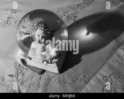 Angel in crystal ball. Concept : light and shadow. Stock Photo