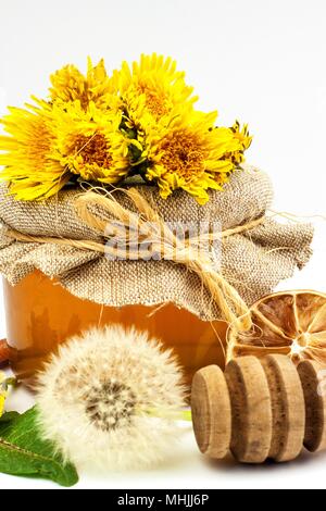 Fresh dandelion honey in a glass. Honey production of dandelions. On a white background Stock Photo