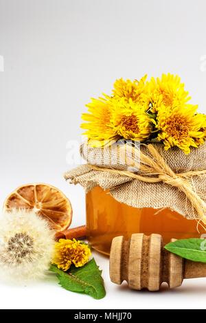 Fresh dandelion honey in a glass. Honey production of dandelions. On a white background Stock Photo