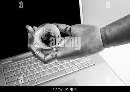 future technology, business and artificial intelligence concept Robot touching virtual earth hologram over laptop screen Stock Photo