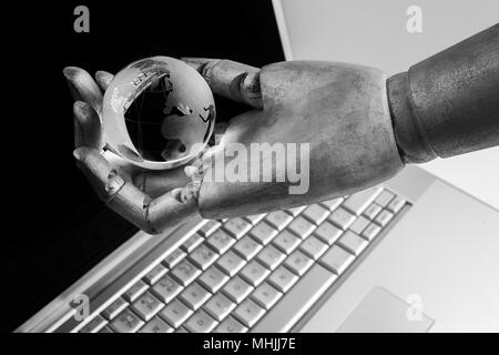 future technology, business and artificial intelligence concept Robot touching virtual earth hologram over laptop screen Stock Photo