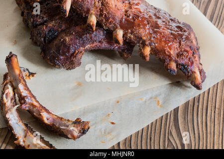 Grilled pork baby ribs with barbecue sauce on backed paper Stock Photo