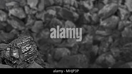 Heap of coal. One rock of coal close up on black coal background. Place for text. Copy space.High quality coal mined in Kuznetzk basin. Coal-basin.Kuzbass, Western Siberia,Russia Stock Photo