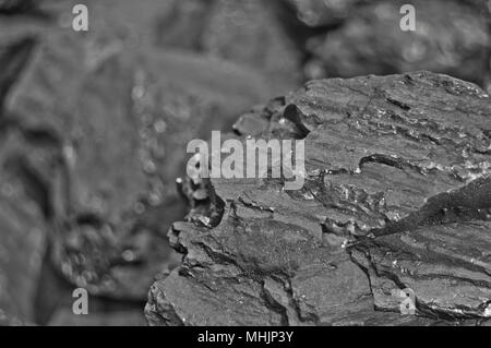 Heap of coal. One rock of coal close up on black coal background. Place for text. Copy space.High quality coal mined in Kuznetzk basin. Coal-basin.Kuzbass, Western Siberia,Russia Stock Photo