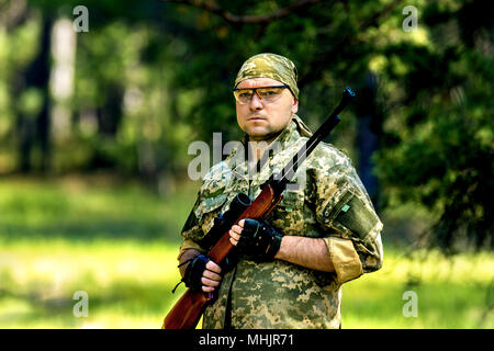 image of a young man with an air rifle Stock Photo