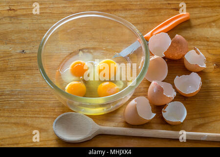 Egg yolks in bowl to be beaten for omelette and scrambled eggs Stock Photo