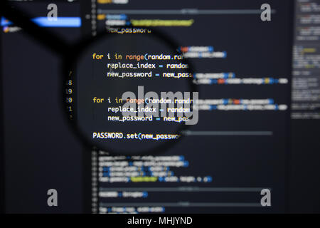 Real Python code developing screen. Programing workflow abstract algorithm concept. Lines of Python code visible under magnifying lens. Stock Photo