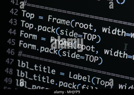 Real Python code developing screen. Programing workflow abstract algorithm concept. Lines of Python code visible under magnifying lens. Stock Photo