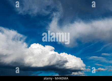 Cumulus clouds against a clear blue Colorado sky Stock Photo