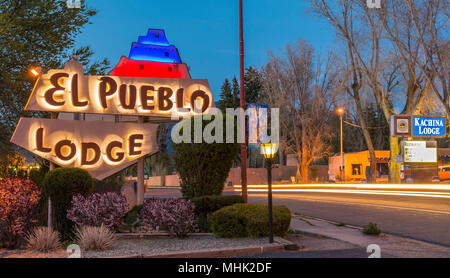 Vintage neon motel signs and traffic light streaks at night on main street in Taos, New Mexico, USA. Stock Photo