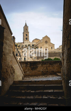 Matera (italy), September 2017. View of the Cathedral dedicated to the Virgin Mary and Saint Eustace, with the surrounding 'Sassi'. Portrait format. Stock Photo