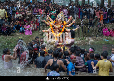 Shillong, northeast India 2012. Indian men about to submerge idol of Hindu goddess during Durga puja festival Stock Photo