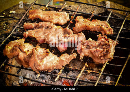 Roasted pork on a charcoal stove Stock Photo