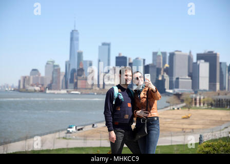 New York, USA. 1st May, 2018. Visitors take selfies at Governors Island in New York, the United States, on May 1, 2018. The island opened to public on Tuesday for its 2018 season. Yards away from lower Manhattan and Brooklyn, it is easily accessible by ferry and open to the public from May 1 to October 31 this year. Credit: Wang Ying/Xinhua/Alamy Live News Stock Photo