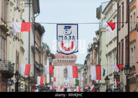 Krakow, Poland. 2nd May, 2018. Small polish flags seen hanging on the street during the National Flag day at the Main Square in Krakow. City scouts, today attempt to break the national record along the length of the national flag. A polish flag with 3 meters wide and more than two kilometers long occupy all the royal road, from the Florian Gate to the Wawel Hill. Credit: Omar Marques/SOPA Images/ZUMA Wire/Alamy Live News Stock Photo