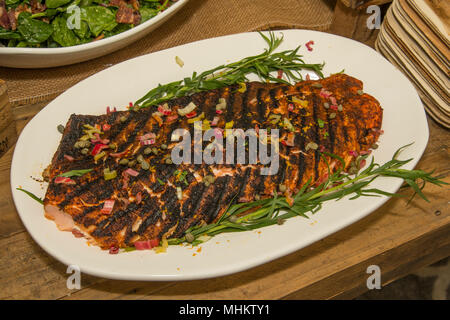 Fish, trout, chum salmon, humpback, a piece baked, grilled, with a slice of  lemon and lettuce Stock Photo - Alamy