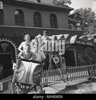 1960s historical mother and children enjoy a ride in open cars on a