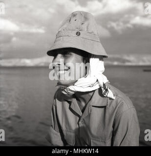 1950s, historical, an attractive Israeli young female conscipt wearing army khaki uniform, scarf and hat, smiles for the camera, Israel. Military conscription in the IDF for all woman aged 18 and over had been mandatory in Israel since 1948. Stock Photo