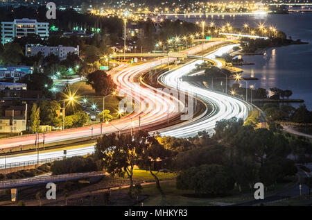 Light trails on a busy Mitchell Freeway at dusk. Stock Photo