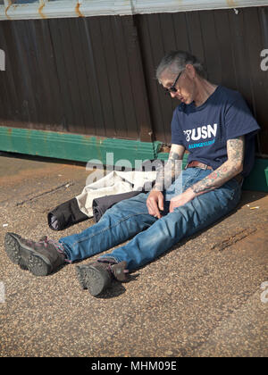 A man who has passed out on the Brighton seafront Stock Photo