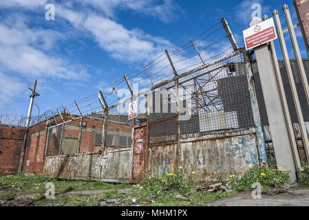 Old, rusty industrial ecurity gate at an abandoned site. Stock Photo