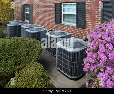 Air conditioning units outside an apartment complex Stock Photo