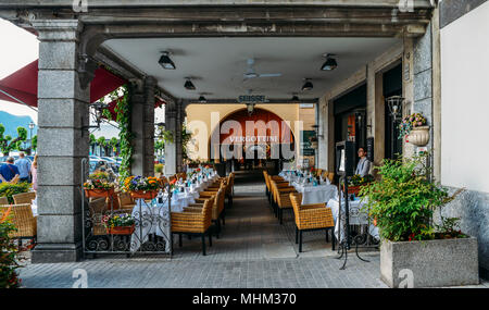 Restaurant tables on a terrace in Bellagio, Lombardy, Italy Stock Photo