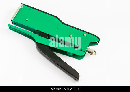 A green stapler on a white background Stock Photo