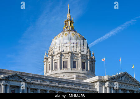 San Francisco City Hall - A close-up view of Golden Dome of City Hall Building, with City, State and USA flags flying at front. San Francisco, CA, USA Stock Photo