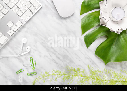 Stylish workspace combining nature and technology. Flat lay composition on marble background, with copy space in the middle. Stock Photo
